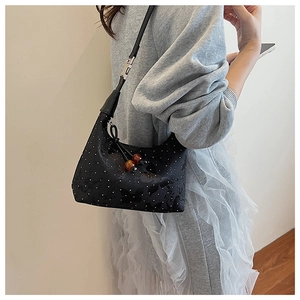 Hobo bag with rhinestone butterfly patterns and amber bead charm shown on model