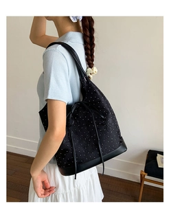 Detailed view of polka dot tote bag with jacquard texture and leather shoulder straps