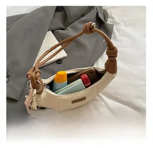 Interior view showing capacity of the pleated dumpling bag for essentials and phone
