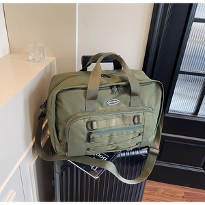 Olive green travel backpack on suitcase with tactical webbing and front elastic cord