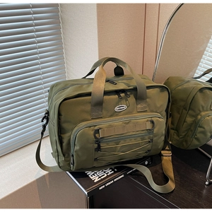 Detail of military green nylon travel bag with HOCOBAG logo and tactical straps
