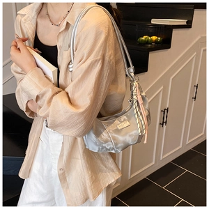 Silver hobo bag detail with pleated texture and stylish braided rope charm accent