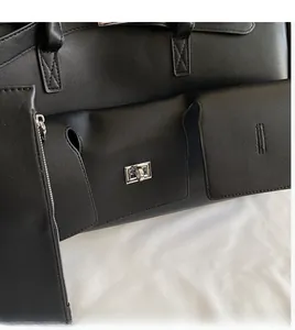 Detail of black leather tote bag with silver metal swivel lock and matching coin purse