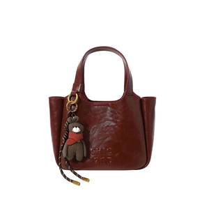 Retro dark red leather bucket handbag for women with chic bear charm and gold rings