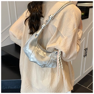 Silver crescent hobo bag with knotted shoulder strap and woven charm detail