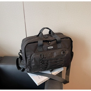 Detail of multi-compartment travel bag with adjustable straps and front bungee cords