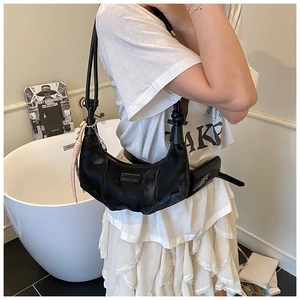 Detail of black pleated half-moon bag with mini pouch on a leather strap for women