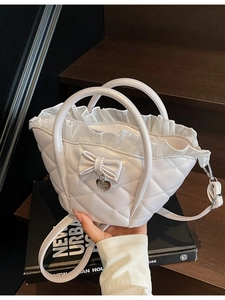 Quilted off-white basket bag with leather bow and lace trim detail for women