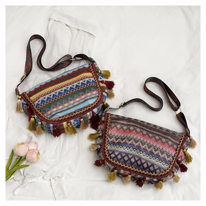 Close-up of Bohemian woven shoulder bags with geometric patterns and colorful tassels
