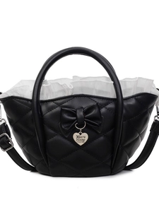 Quilted black bucket bag with ribbon bow and heart pendant on white background