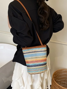Colorful woven straw bucket bag with brown leather strap for summer vacation style