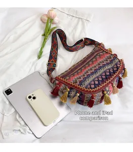 Ethnic embroidered canvas bag size comparison with a phone and tablet showing large capacity