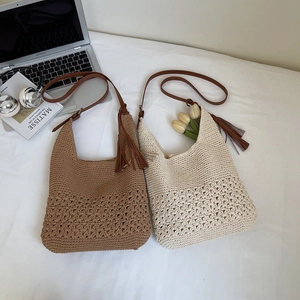 Detail of bohemian woven beach bags with intricate hollow knit patterns and leather straps