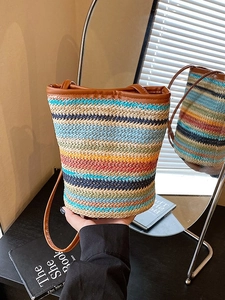 Colorful striped woven straw bucket bag with brown leather shoulder straps for summer