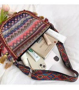 Detail view of ethnic canvas bag with tassel accents and spacious interior storage