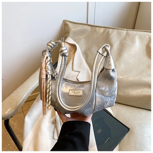 Detail of silver marble textured crescent bag with knotted handle and colorful charm