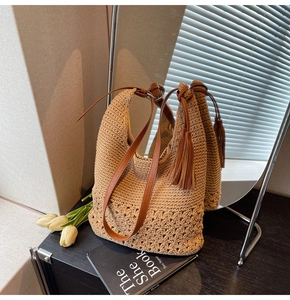 Detail of crochet woven tote bag featuring hollow patterns and brown leather straps