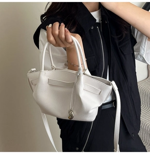White lychee leather bucket bag with silver heart charm and tubular top handles