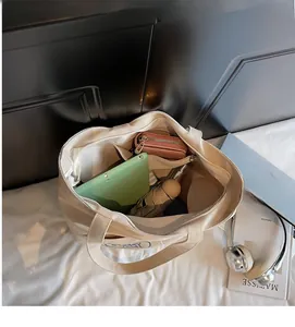 Interior view of canvas tote bag showing spacious compartments and storage capacity