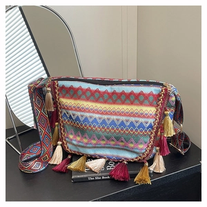 Detail of bohemian woven bag featuring colorful geometric patterns and long silk tassels