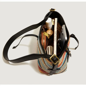Interior view of colorful woven tote bag showing daily essentials and leather straps