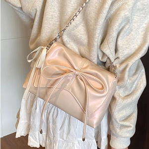 Champagne gold bow shoulder bag with silver chain strap for elegant ballet style fashion