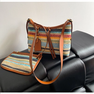 Detailed view of rainbow striped straw shoulder bag with brown leather straps and pouch
