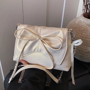 Ballet style cream white crossbody bag with large bow and silver chain strap