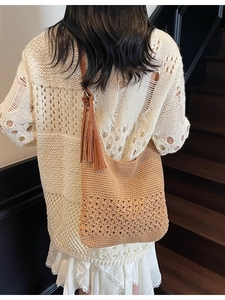 Large hand-woven straw shoulder bag with floral crochet pattern and boho fringe tassel