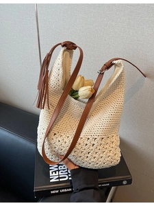 Minimalist beige woven shoulder bag with brown tassels for beach and summer shopping
