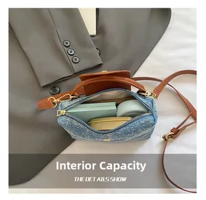 Detail of the denim crossbody bag interior showing storage for makeup and accessories