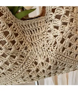 Close-up of beige hollow-out woven tote bag featuring textured knit and fabric lining