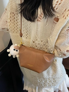 Sac bandoulière marron style dumpling avec pendentif monstre peluche et logo doré chic