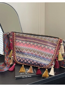 Bohemian woven shoulder bag with colorful geometric patterns and fringe tassel detail