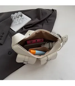 Spacious interior of white multi-pocket hobo bag showing umbrella and wallet storage