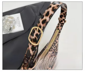 Macro shot of Leopard print shoulder bag with gold hardware and adjustable strap buckle