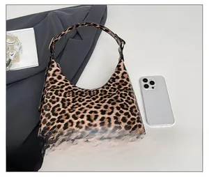 Detail view of leopard print tote bag with smart phone showing spacious inner capacity