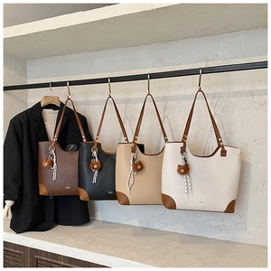 Detailed display of vintage tote bags in four colors with textured leather and bear charms