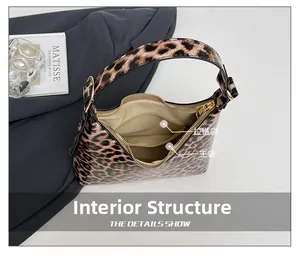 Detailed view of the leopard print bag interior with a main compartment and zipper pocket