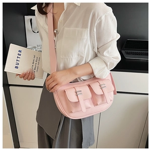 Detail of pink multi-pocket crossbody bag with matte PU texture and metal buckles