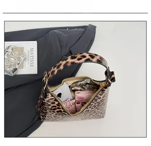 Detail showing the large capacity of the leopard print hobo bag with daily essentials