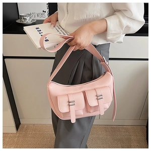 Detail view of pink leather hobo bag with double front flap pockets and silver hardware