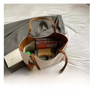 Spacious interior of two-tone tote bag with tablet and daily essentials storage