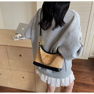 Détail du sac bandoulière en daim camel et cuir noir avec motif losanges surpiqués