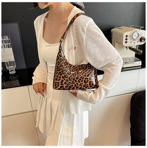 Detail of glossy leopard print shoulder bag featuring vintage hobo shape and shiny finish