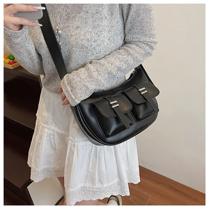 Detail of hobo bag showing functional utility pockets and silver metal buckles