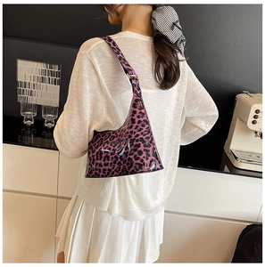 Close-up of the glossy purple leopard print shoulder bag worn as a trendy underarm bag