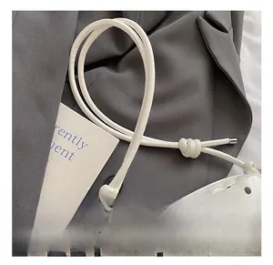 Detailed shot of the adjustable shoulder strap with knot design on polka dot bag