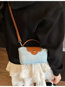 Chic light blue denim square crossbody bag with brown leather trim and metal clasp