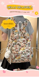 Detail of cute cream school backpack with 3D teddy bears and colorful floral patterns